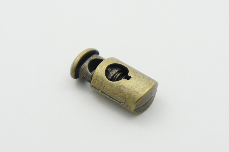 Фіксатор для шнура Mertbutton одинарний стара латунь 12х25 мм